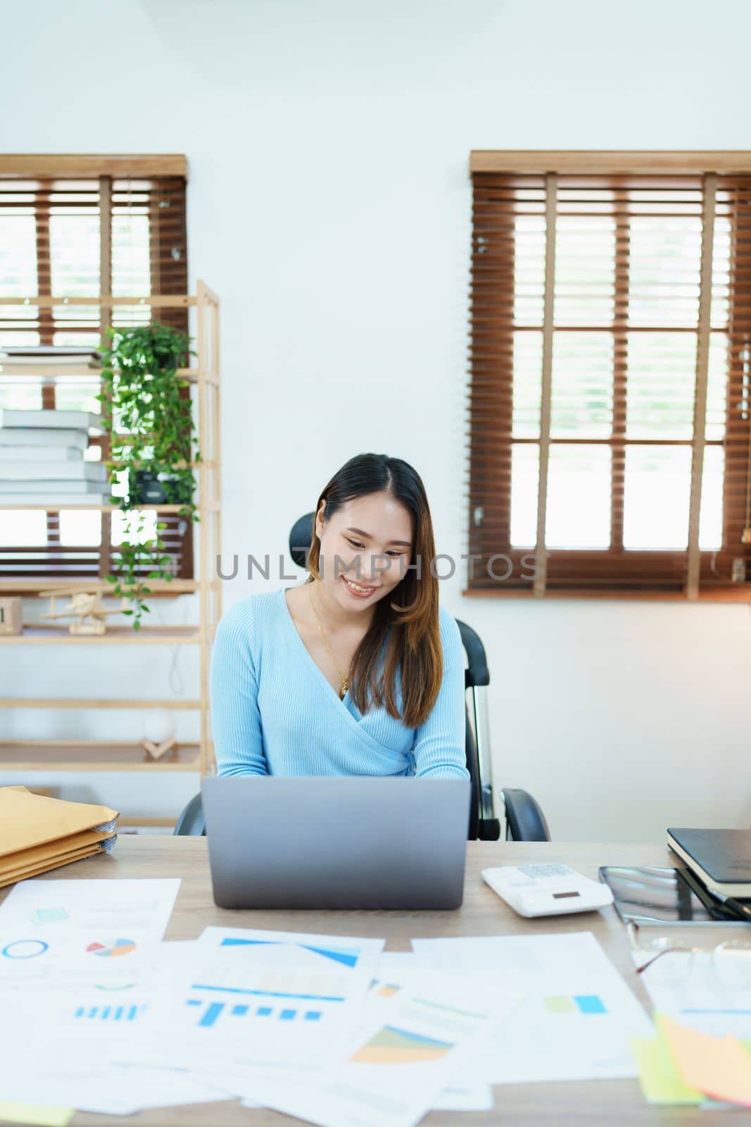 Accountants, Asian auditors are using calculators and computers to review annual tax budgets to submit information to the IRS