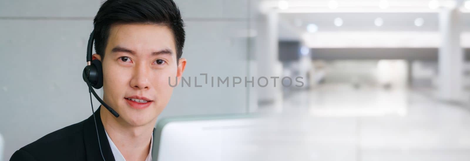 Business people wearing headset working in office in widen view by biancoblue