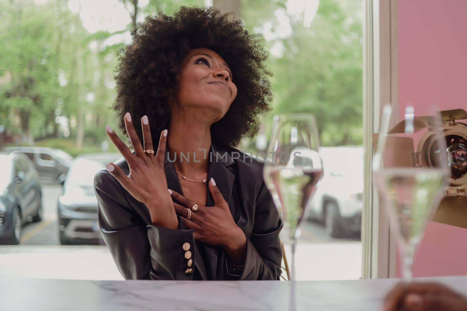 Young attractive African woman with happy cheerful smile drinking and having fun in a bar