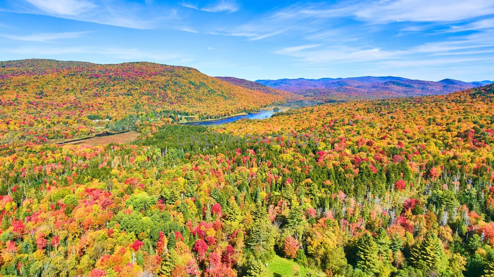 Image of New York landscape aerial of colorful fall forests and mountains with small lake