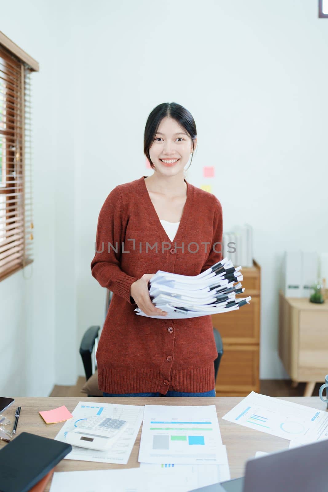 financial, Planning, Marketing and Accounting, portrait of Asian employee checking financial statements using documents and computer at work..