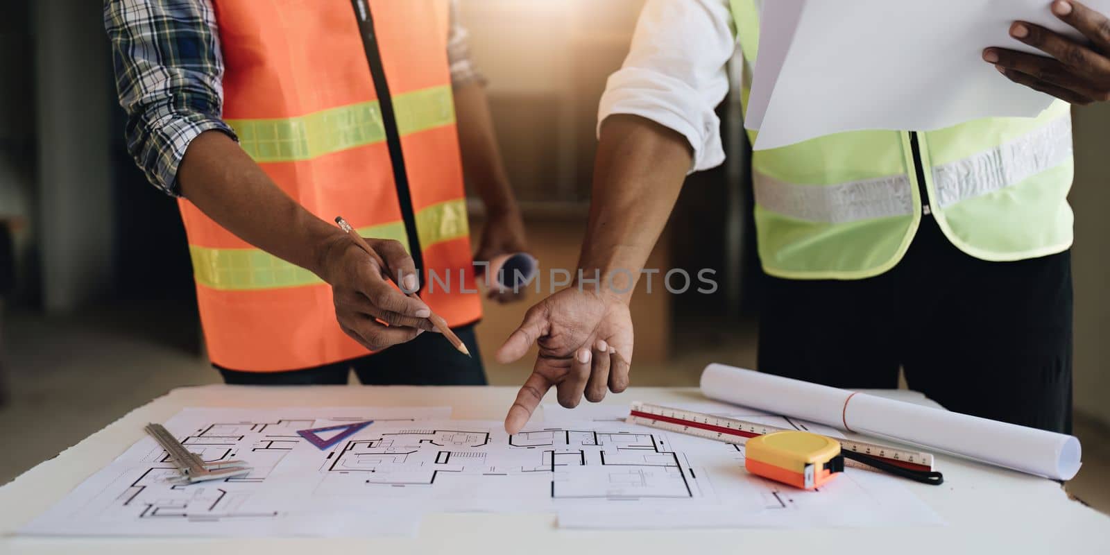 Professional architect designer structural engineer team colleagues discussing building plan design project.