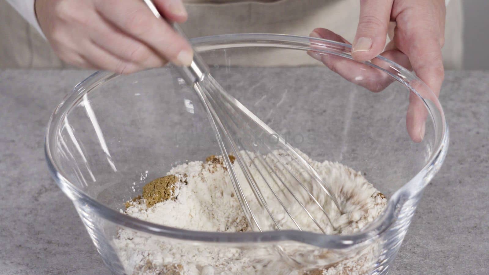 Step by step. Mixing ingredients in the glass mixing bowl to make pumpkin pancakes.
