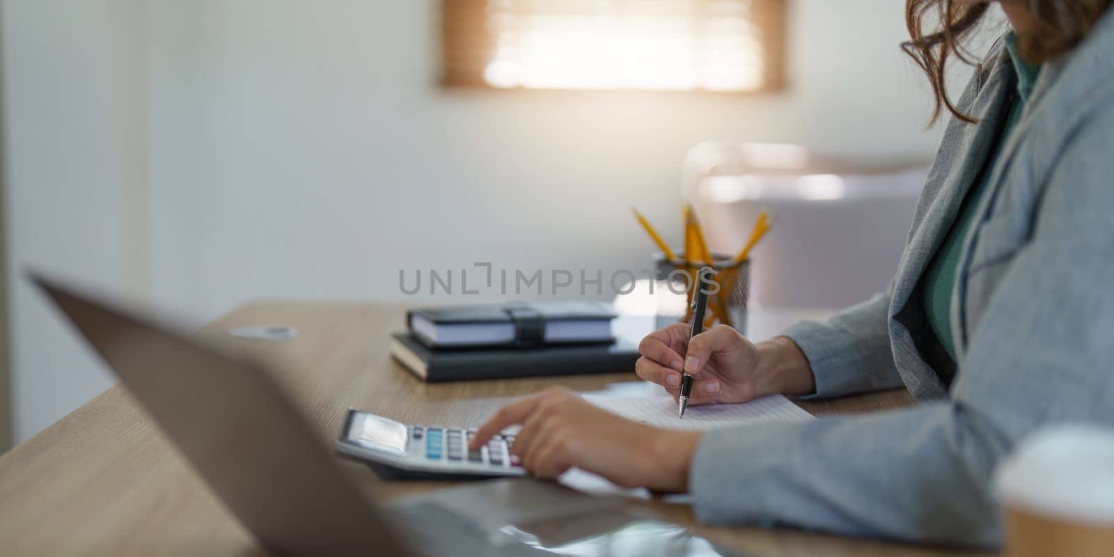 Asian Business woman working at home office and analyze financial report document. Accounting and Finance concept. by itchaznong