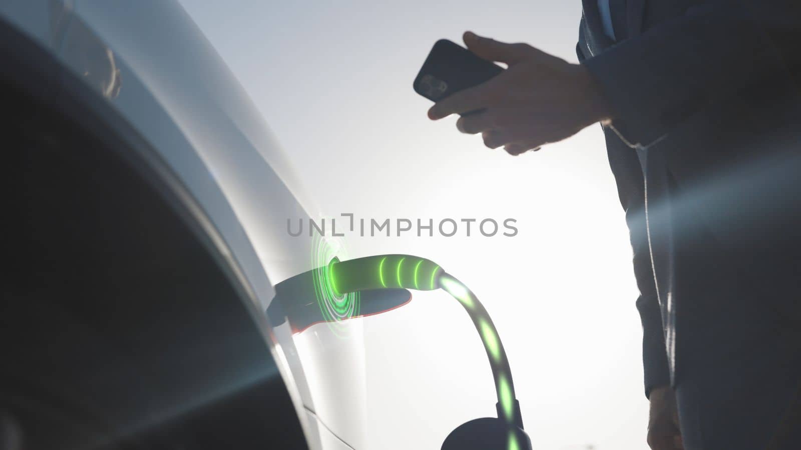 Animation of Businessman attaching power cable to electric car. Electric vehicle recharging battery charging port. Unrecognizable man charging electric car at charging station using smart phone app by uflypro