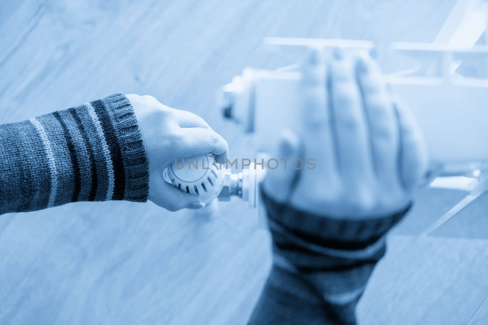 Radiator adjustment closeup, Female hand adjusting radiator temperature