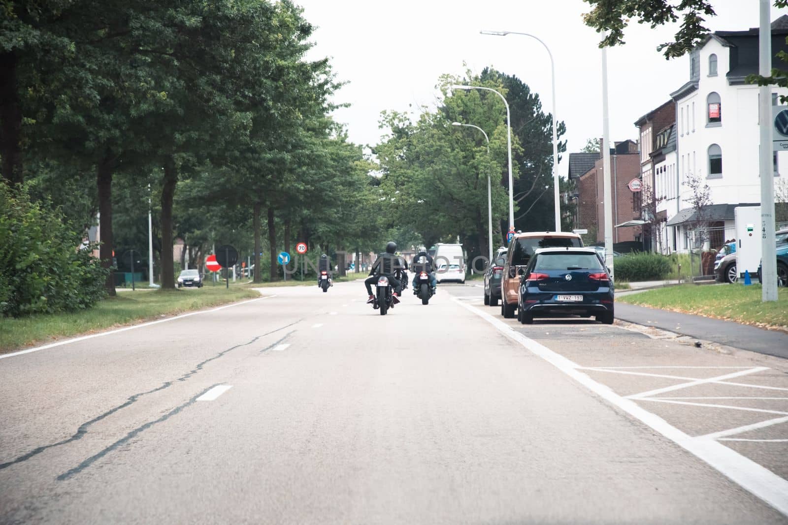 Genk, BELGIUM, August 18, 2021: red traffic lights on the road, cars stopped at the crossroads, High quality photo