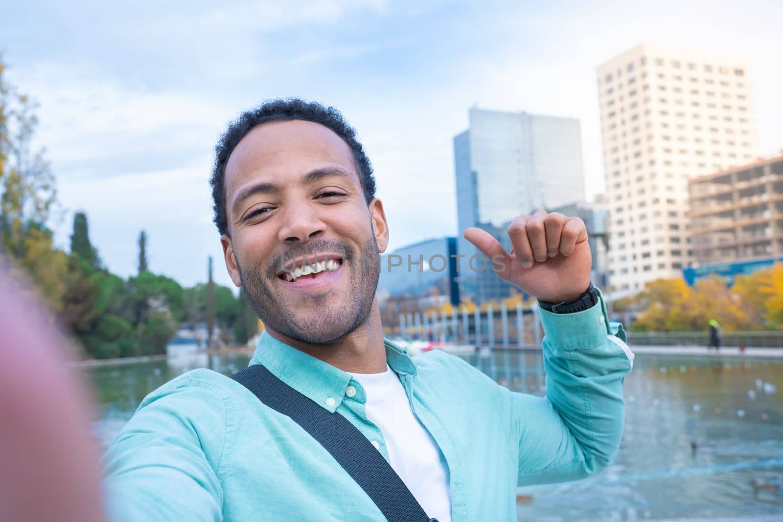 Young African American man taking a selfie looking at camera smiling - Tourist student by PaulCarr