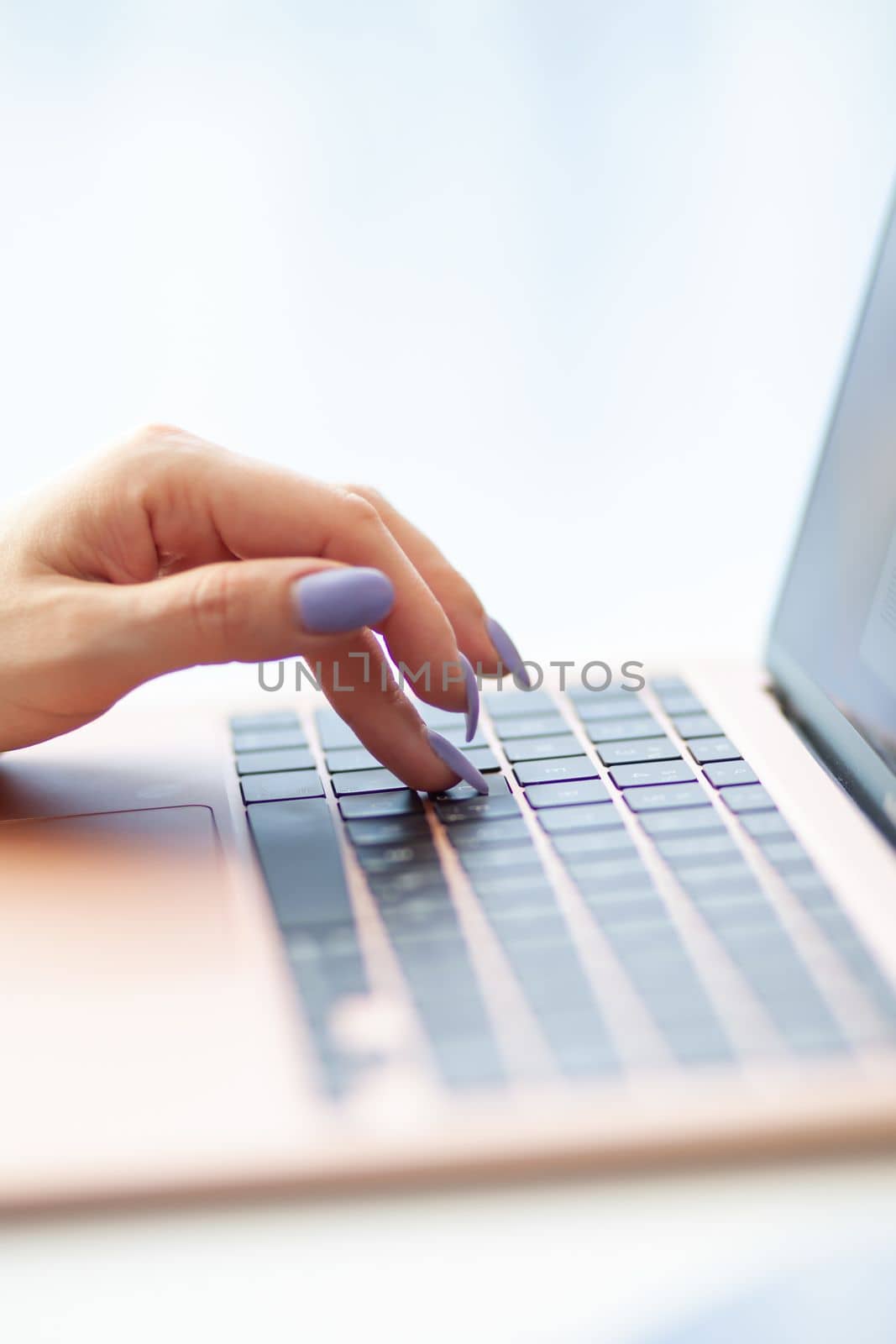 Purchases via the Internet and payment for services buy credit card. Hands type text and enter data on the laptop keyboard. An office worker checks his email while sitting at his desk