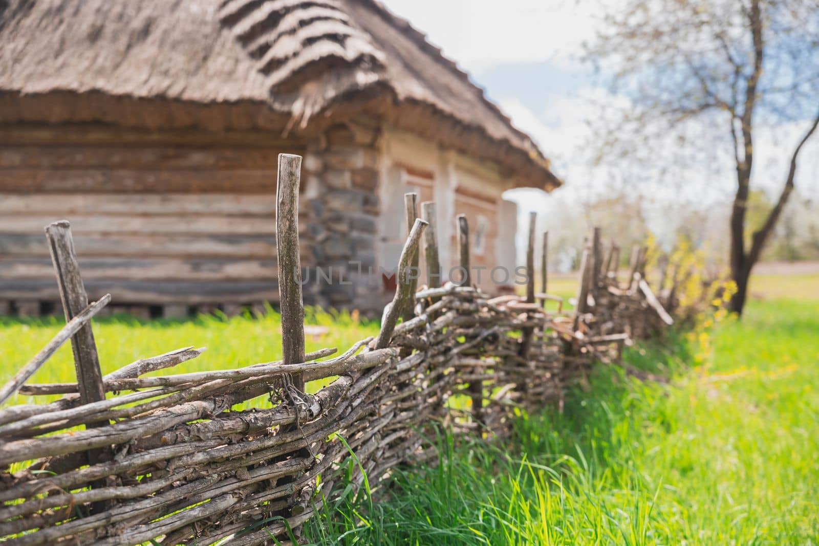 wicker fence near an old traditional Ukrainian house.