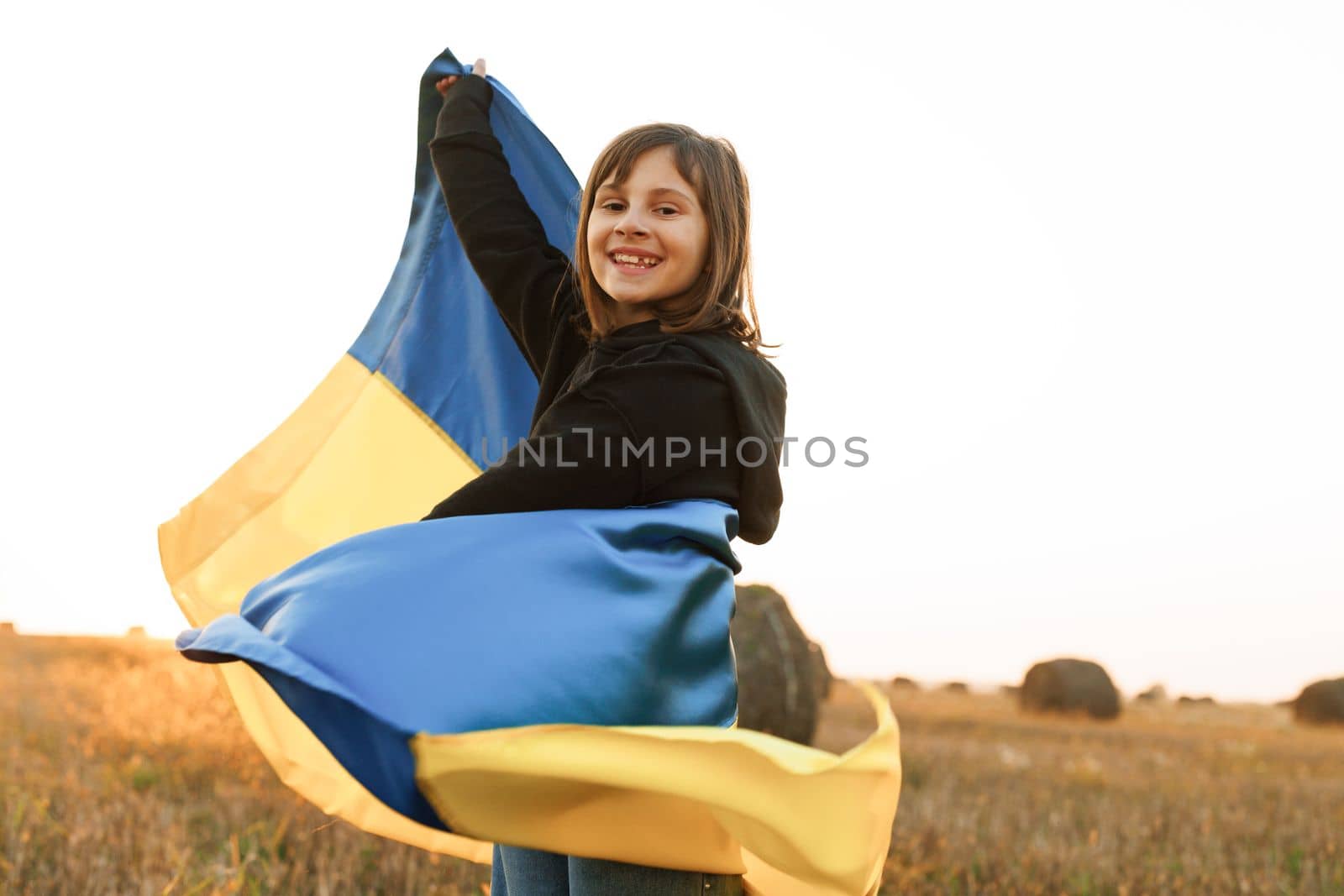 Portrait of pretty slim girl with yellow-blue flag of Ukraine in field. lifestyle. Love Ukraine concept. Independence day of Ukraine, Flag, Constitution day Education, school, art concept. by uflypro