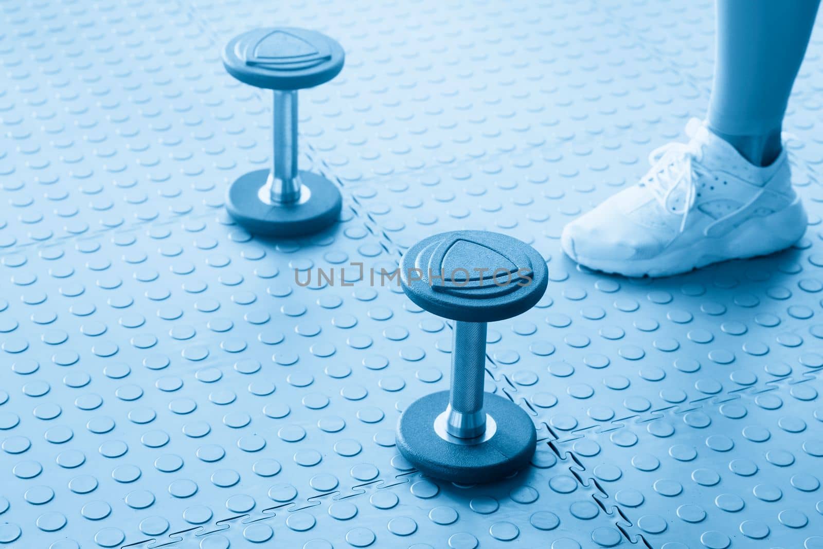 dumbbell exercise weights standing on the floor in gym by Mariakray