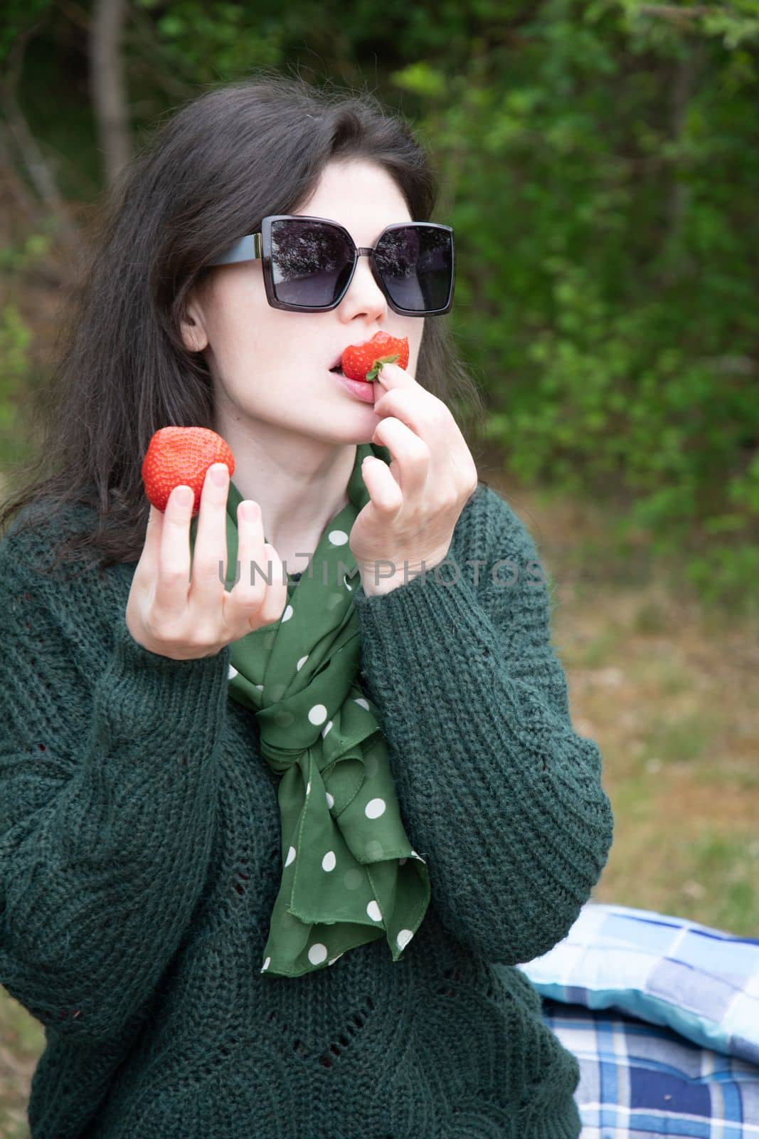 young beautiful brunette woman eat strawberry dessert at picnic on the bench High quality photo