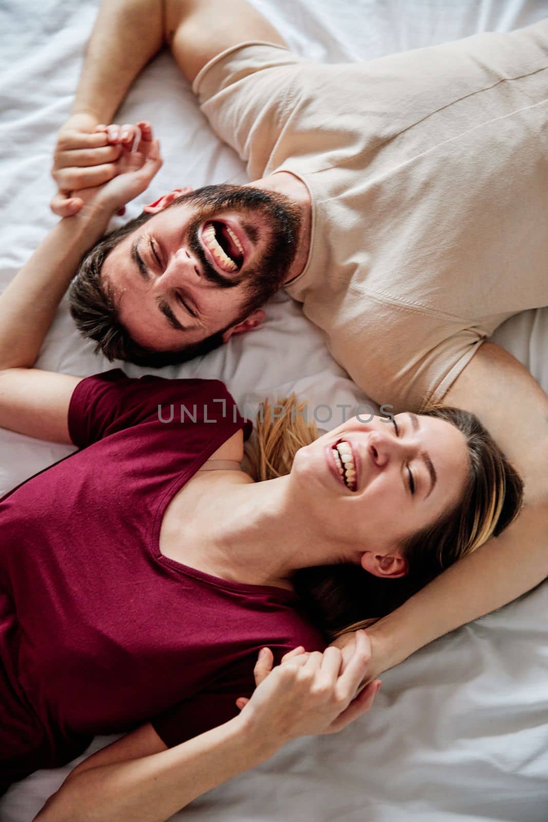 couple love bedroom bed lying romance happy relationship valentine day together man woman by Picsfive