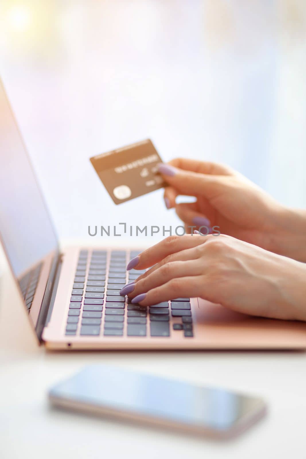 Purchases via the Internet and payment for services buy credit card. Hands type text and enter data on the laptop keyboard. An office worker checks his email while sitting at his desk