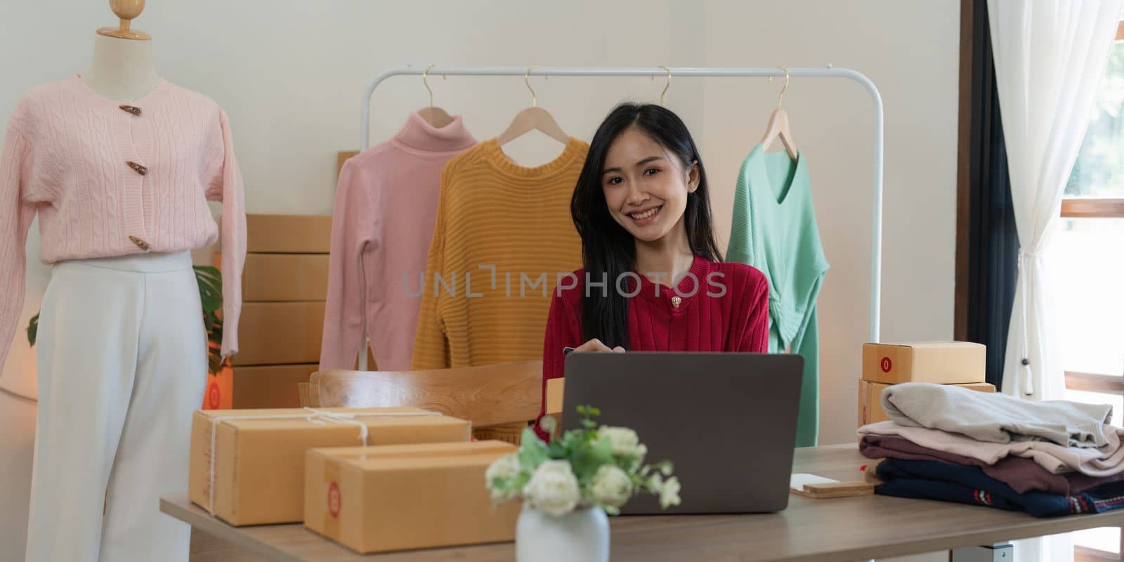 Startup small business entrepreneur of freelance Asian woman using a laptop with box Cheerful success online marketing packaging box and delivery SME idea concept.