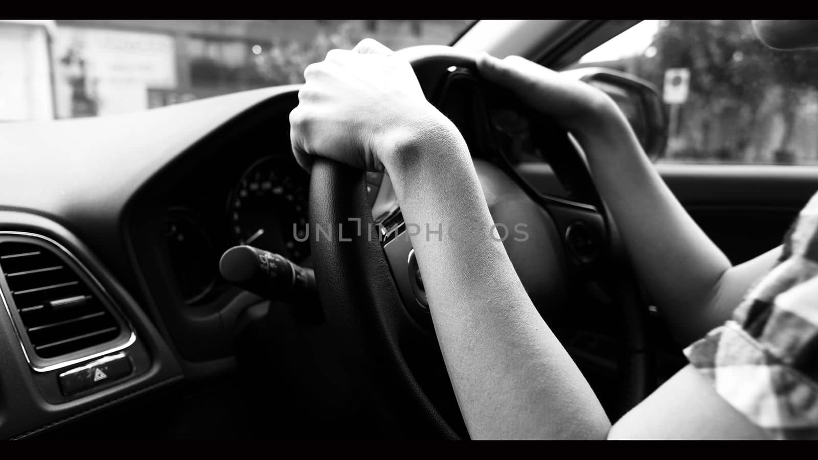 Close-up images of woman hands driving car with confidence. by gnepphoto