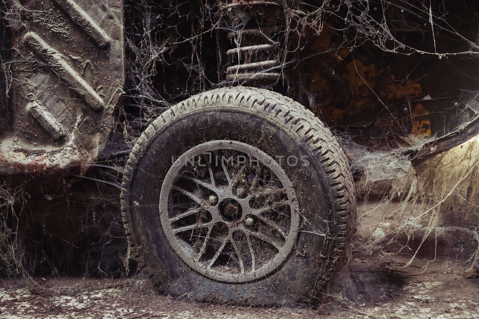 Old disassembled car in an abandoned factory.