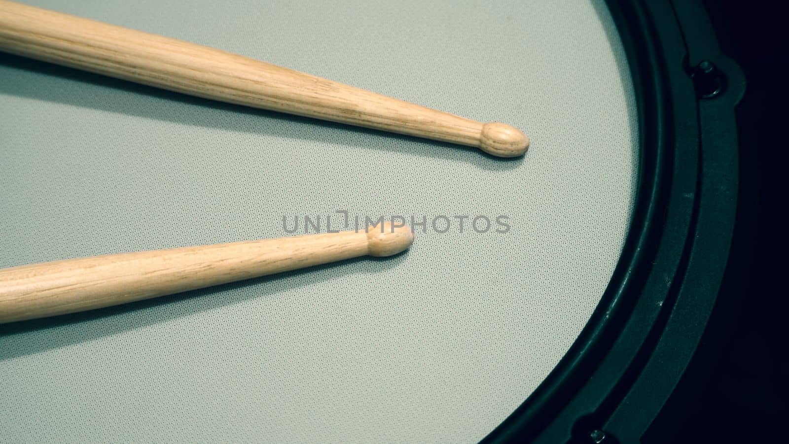 Close-up images of drumsticks on electronic drum snare pad which is main music instrumental to make beat for musician or songwritter and equipment for recording in sound design studio by drummer