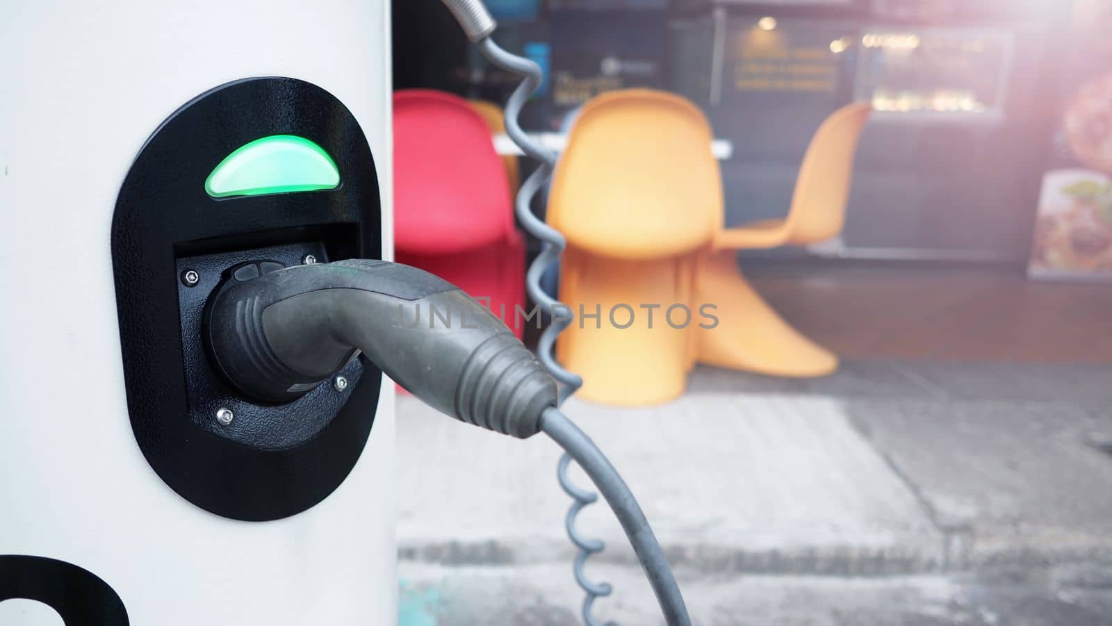 EV charger that have charging cable in plug socket by gnepphoto