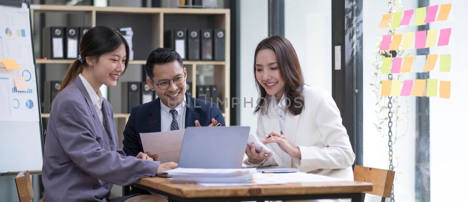 Group of young asian modern people in smart casual wear having a brainstorm meeting. Group of young asian business people discussing in the meeting...