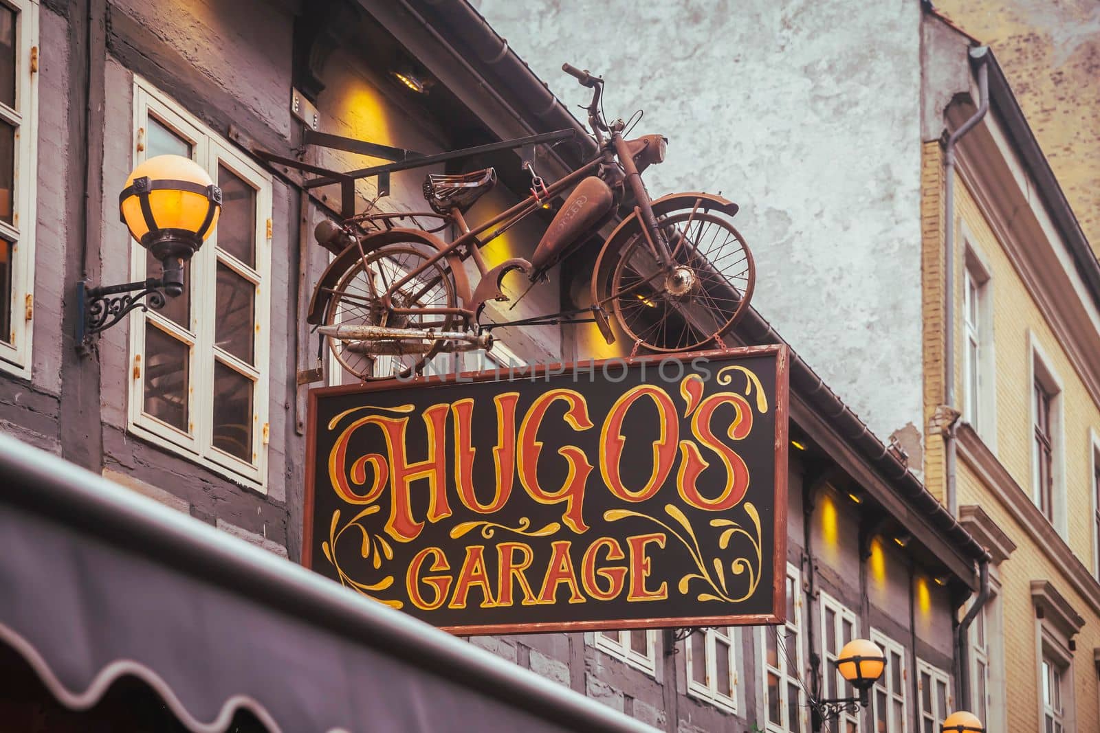 Aalborg, Denmark, October 2021: Bar with a vintage bike on the roof.