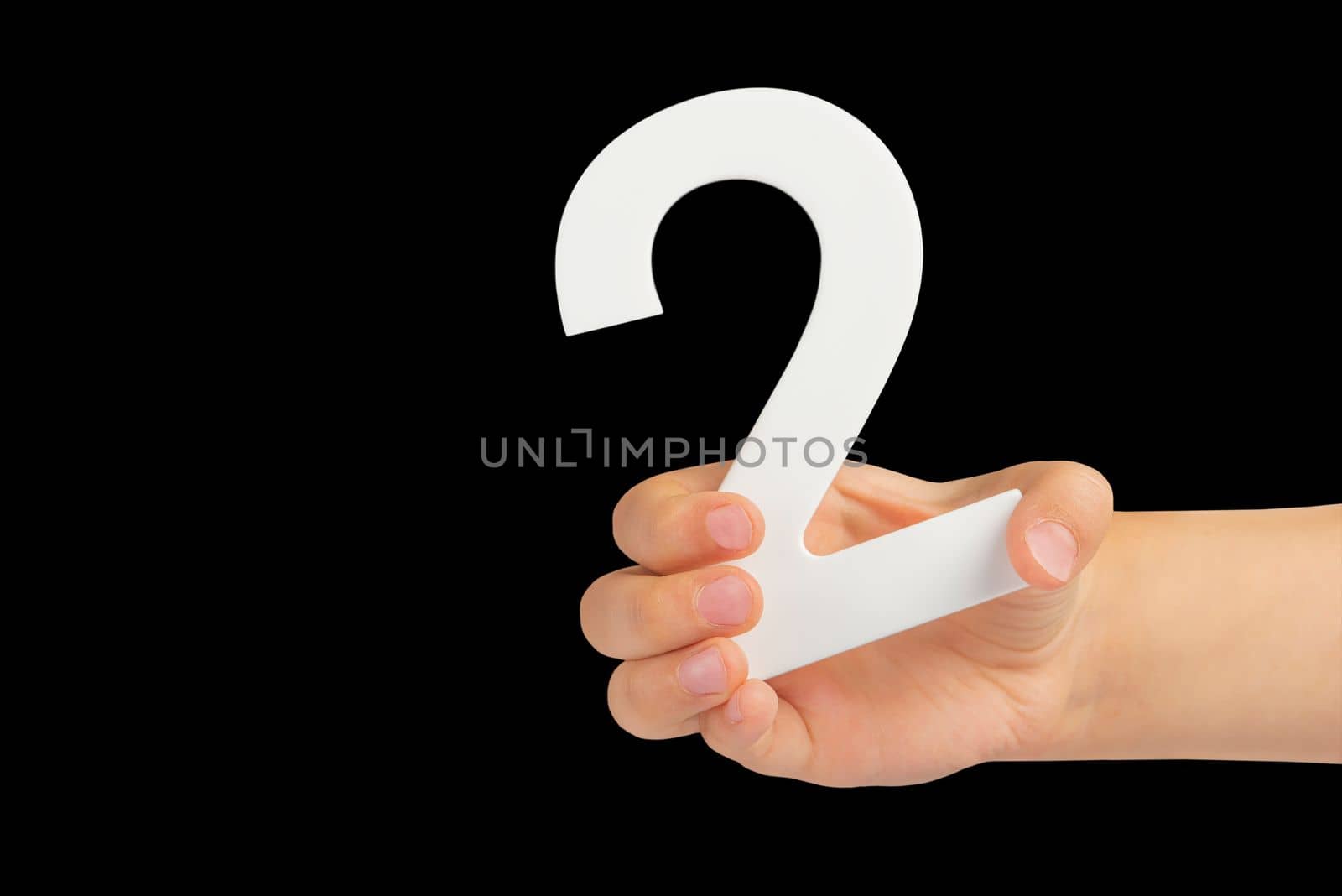 number two in hand isolated on black background. Number two white in a child's hand on a black background. For inserting into a project or design. by SERSOL