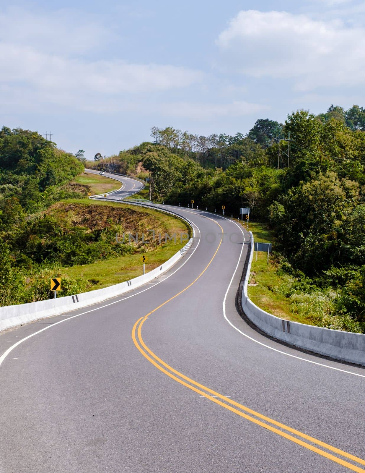 Curved road in the mountains of Nan Thailand, Road nr 3country road rear view. Number three of the road among the mountains at Nan, Thailand. couple man and women on vacation in Nan Thailand.