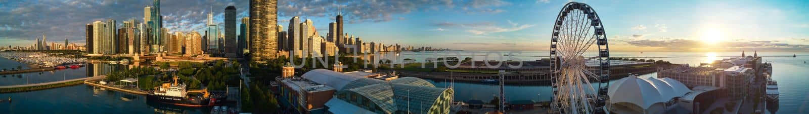 Stunning panorama of Chicago Navy Pier at sunrise with ferris wheel and city skyline by njproductions