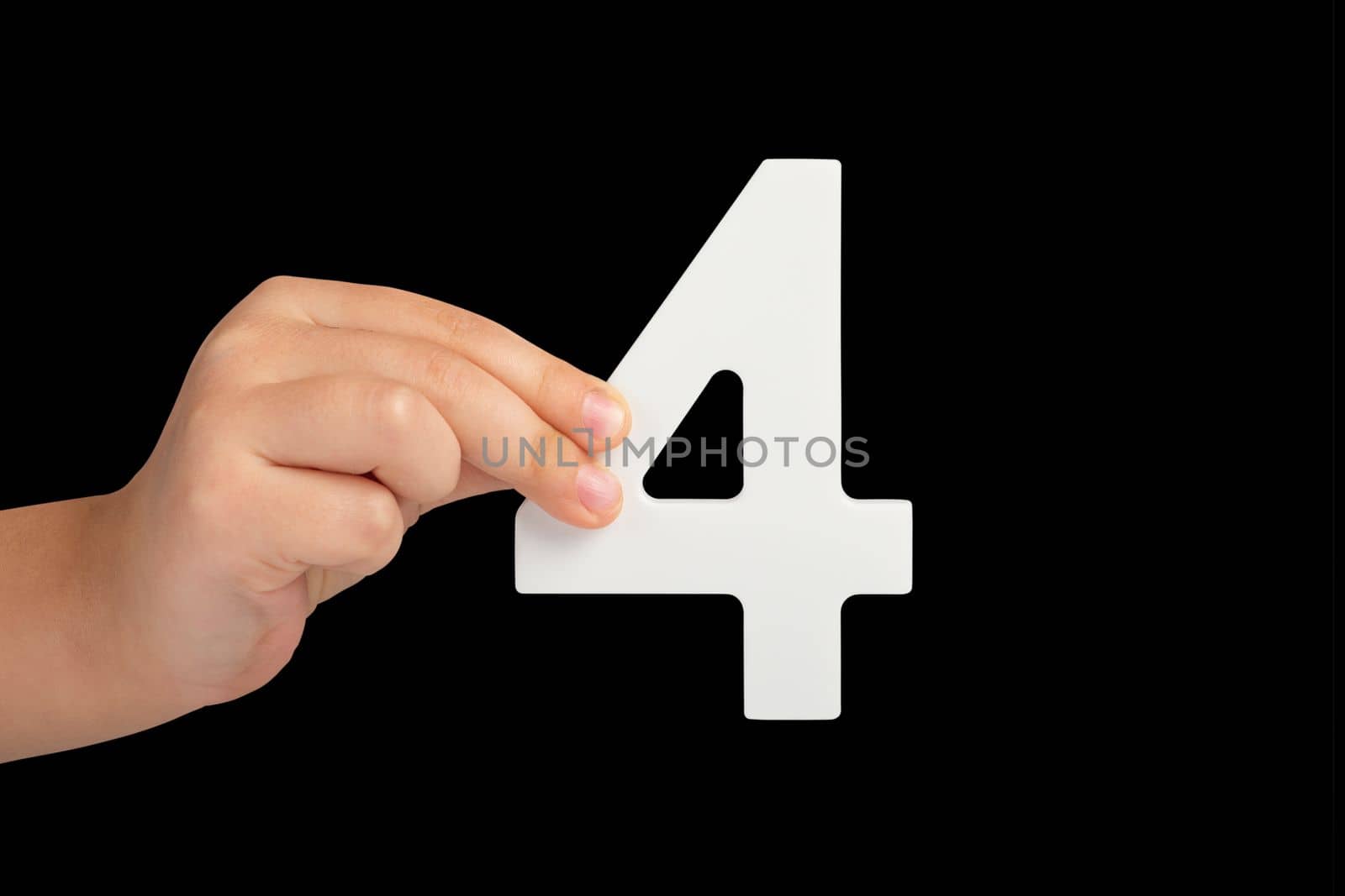 Number four in hand isolated on black background. Number four in a child's hand, holding on a black background. To be inserted into a project or design