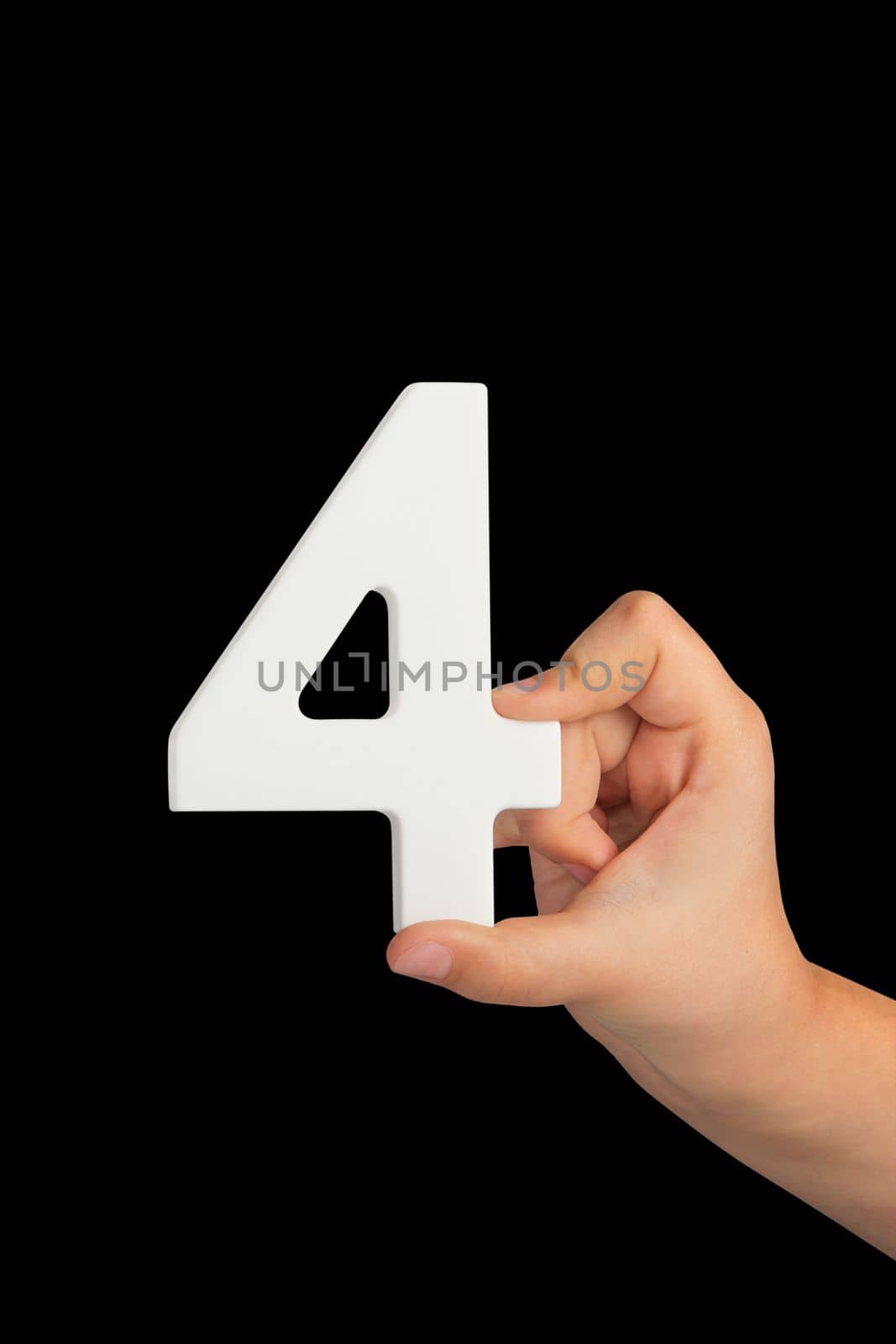 Number four in hand isolated on black background. Number four in a child's hand, holding on a black background. To be inserted into a project or design