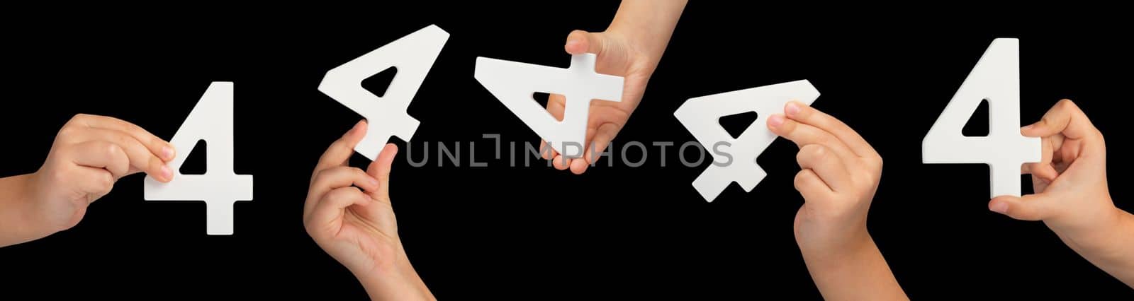 Number four in hand isolated on black background. Number four in a child's hand, holding on a black background. A large set of hands with numbers to insert into a project or design.