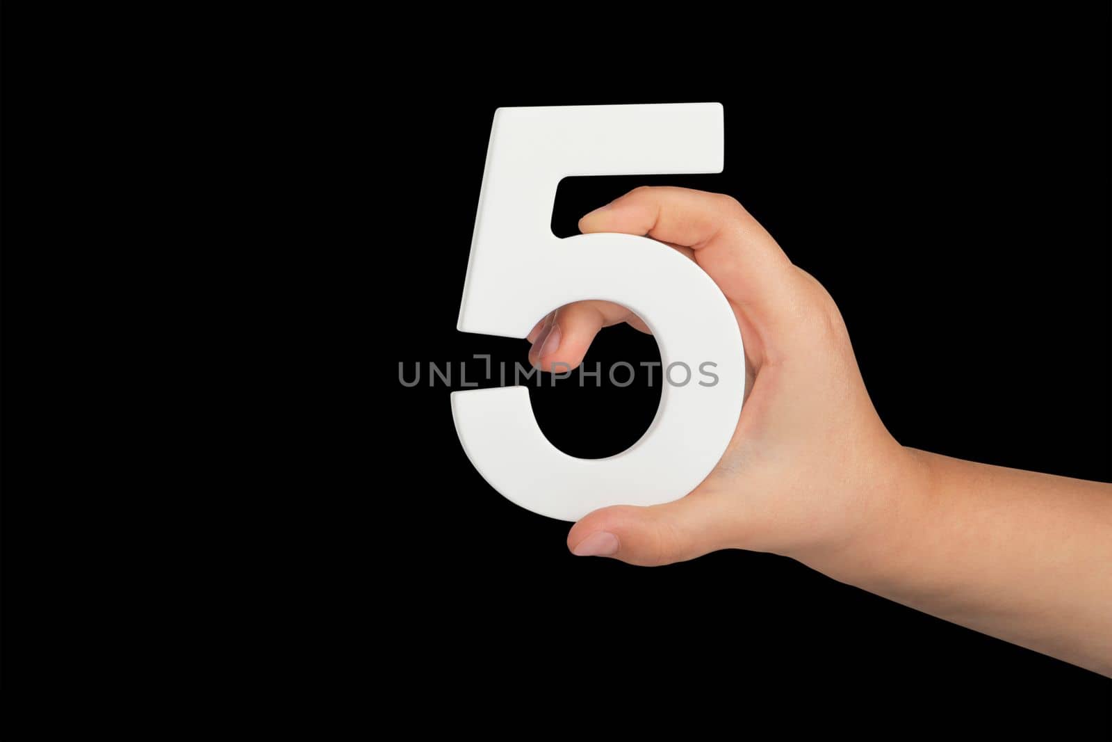 Number five in hand isolated on black background. Number five in the hand of a child holding on a black background. To be inserted into a project or design. by SERSOL