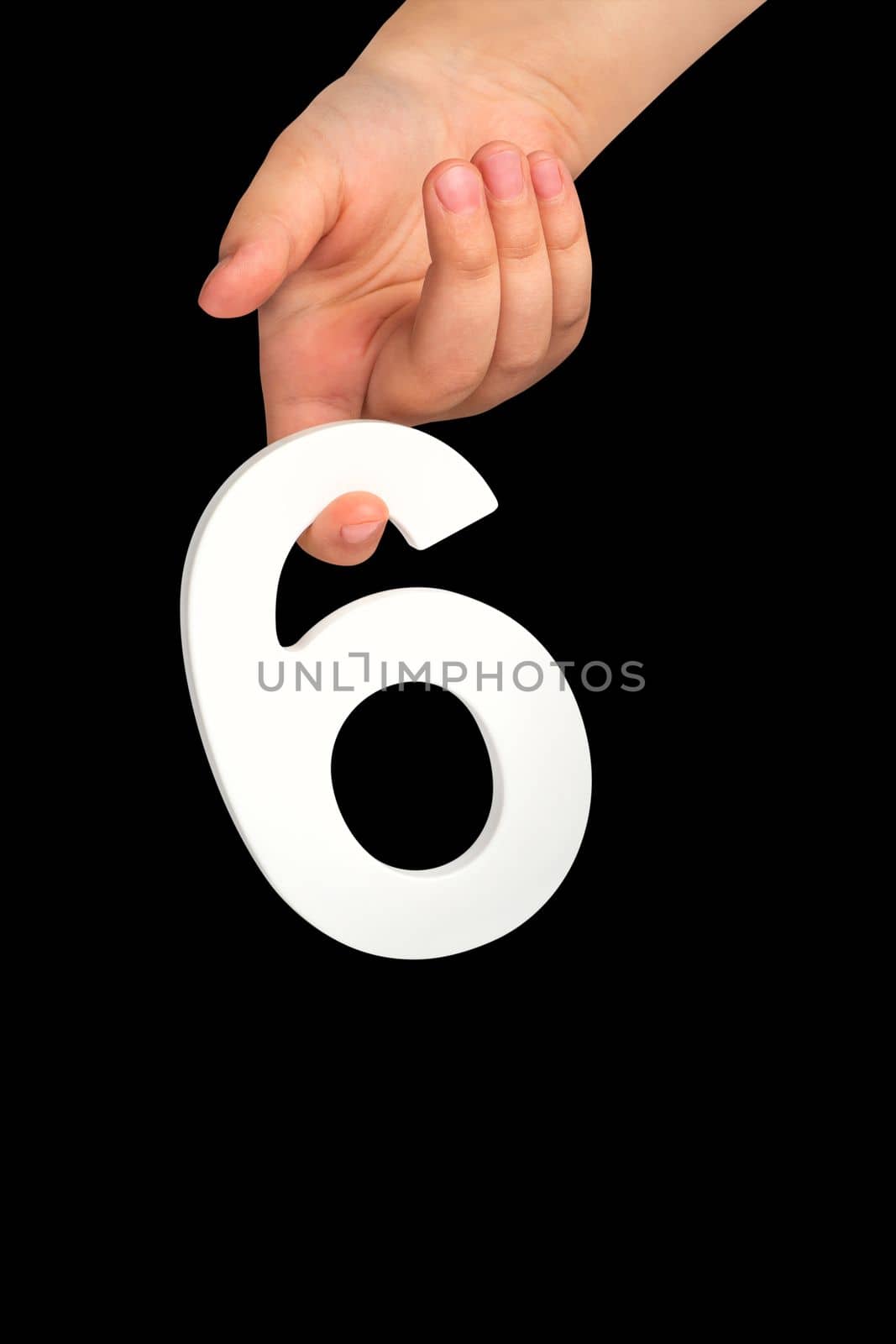 Number six in hand isolated on black background. Number six in a child's hand holding on a black background. To be inserted into a project or design. by SERSOL