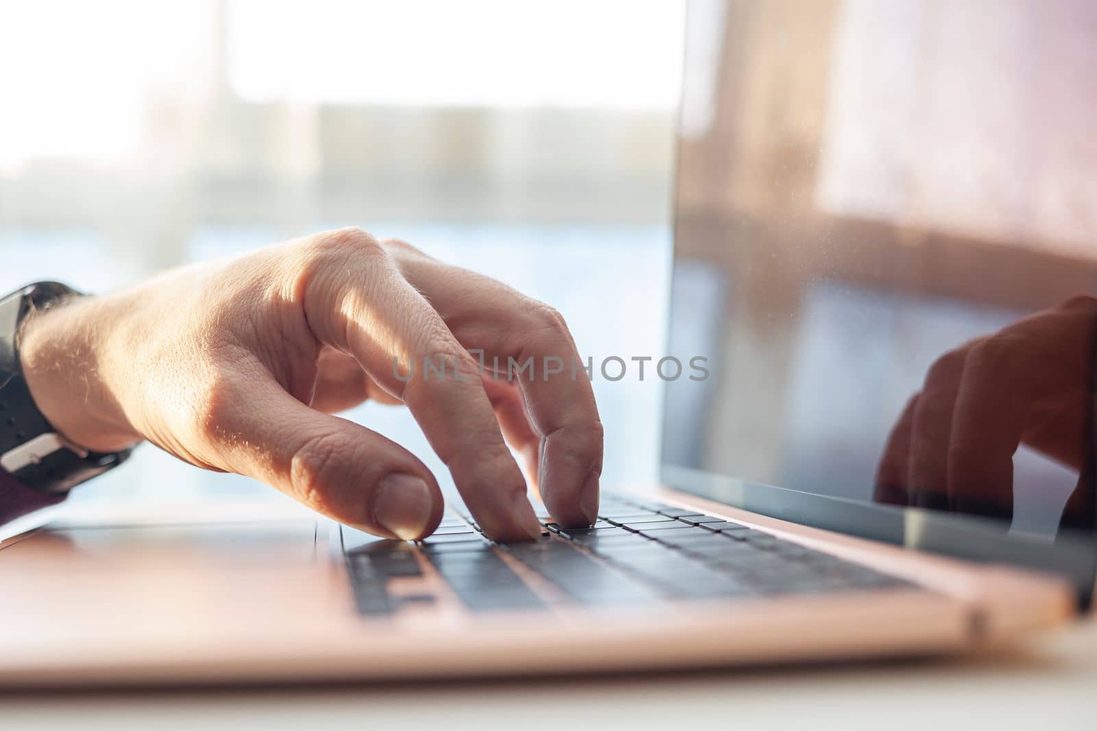 Purchases via the Internet and payment for services buy credit card. Hands type text and enter data on the laptop keyboard. An office worker checks his email while sitting at his desk