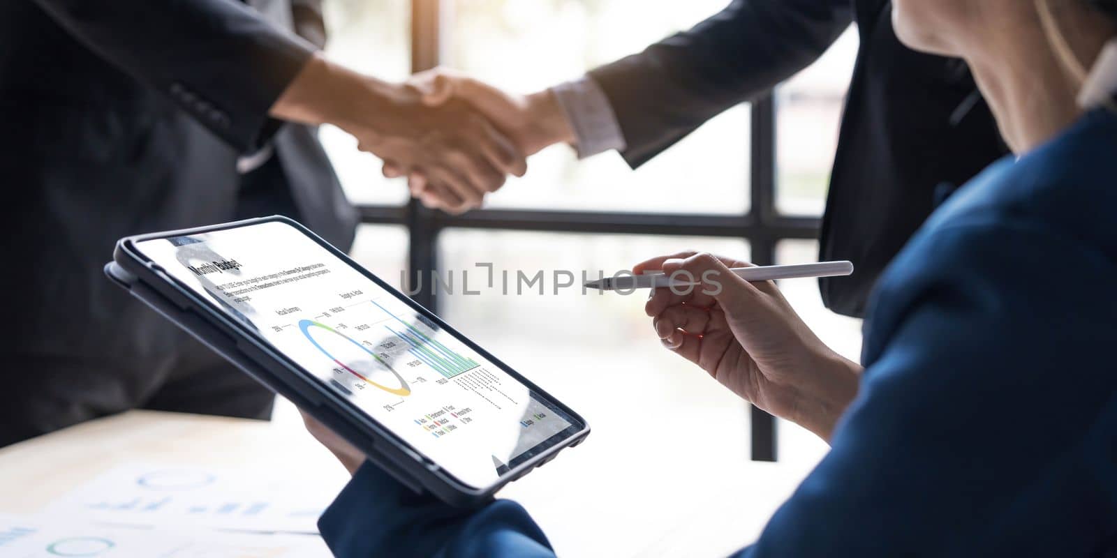 Business handshake for teamwork of business merger and acquisition,successful negotiate,hand shake,two businessman shake hand with partner to celebration partnership and business deal concept by wichayada