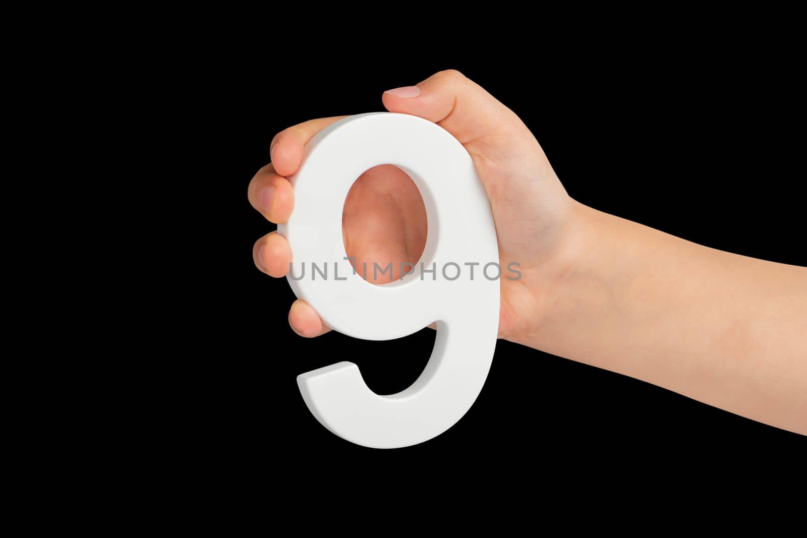 Number nine in hand isolated on black background. Number 9 in a child's hand on a black background. To be inserted into a project or design