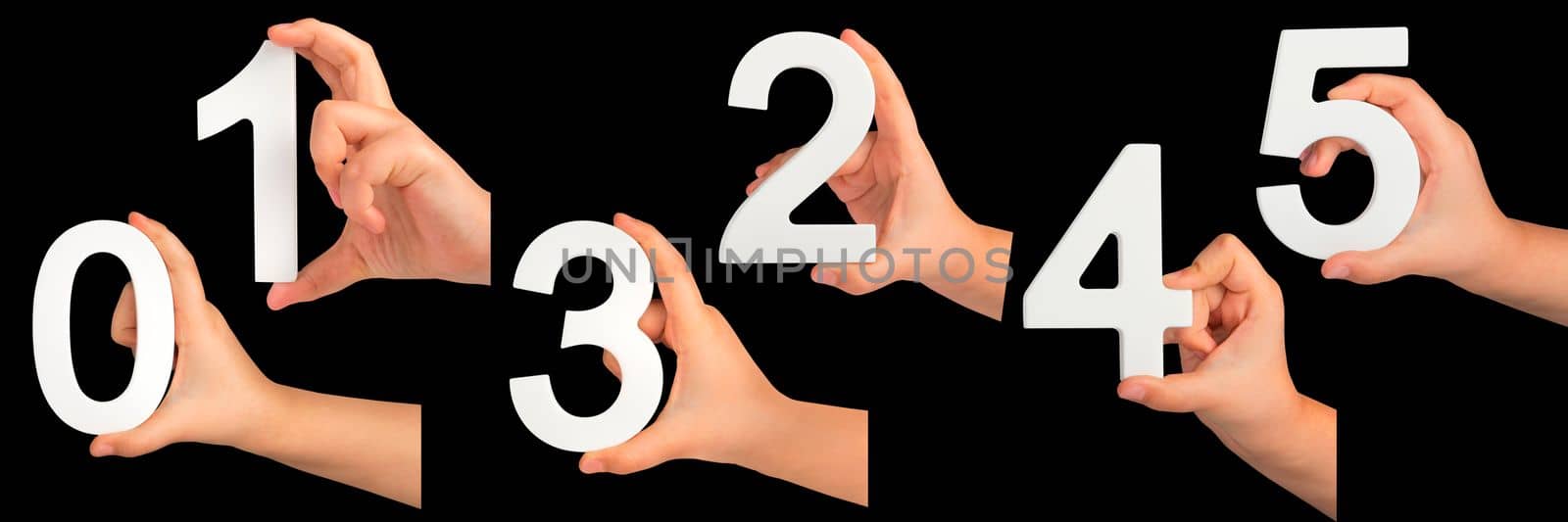 Children's hands hold numbers. A set of white numbers in hands on a black isolated background. Zero, one, two, three, four, five