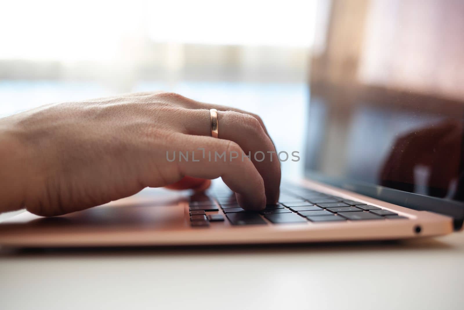 Purchases via the Internet and payment for services buy credit card. Hands type text and enter data on the laptop keyboard. An office worker checks his email while sitting at his desk