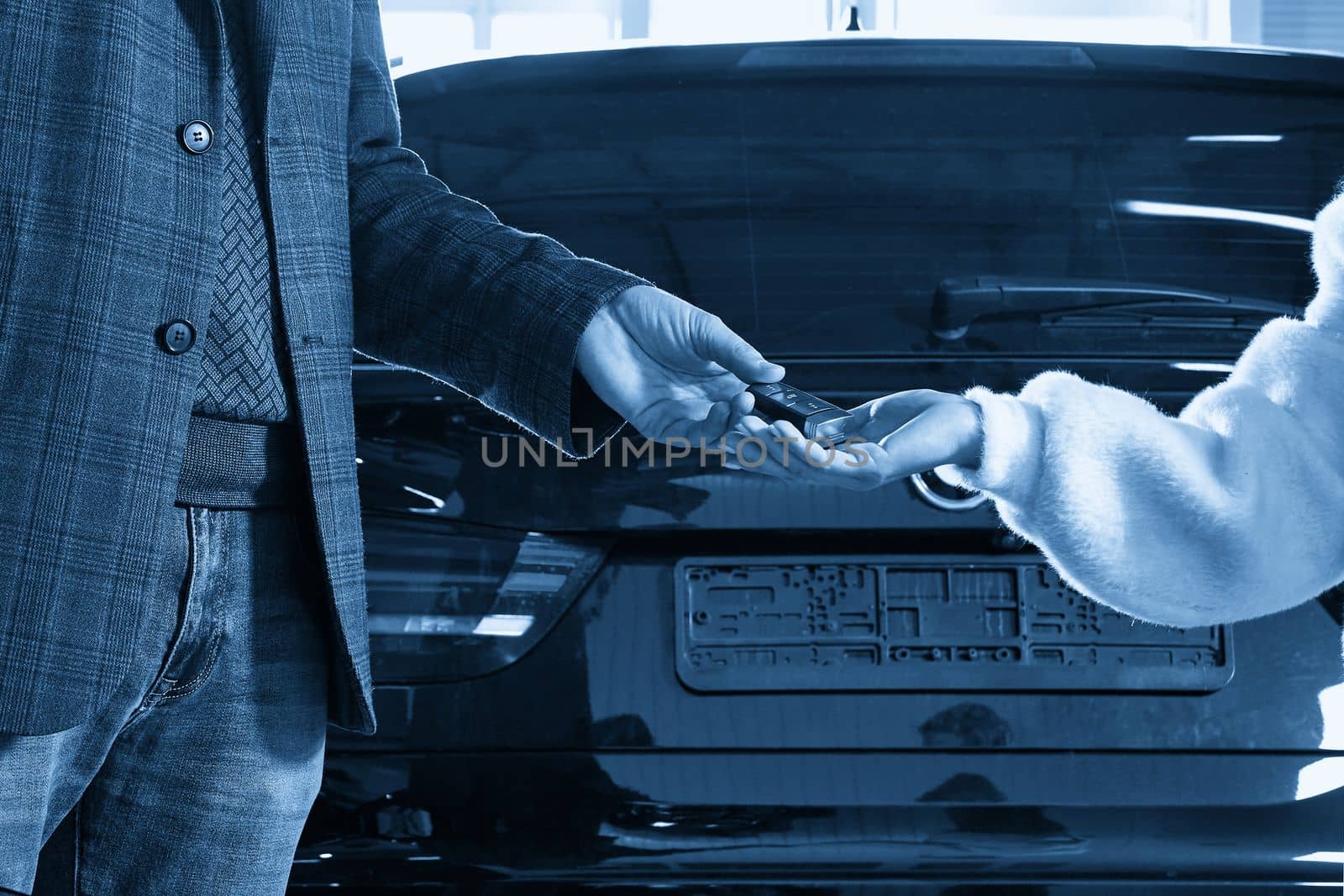 Mechanic giving car keys to customer after servicing by Mariakray