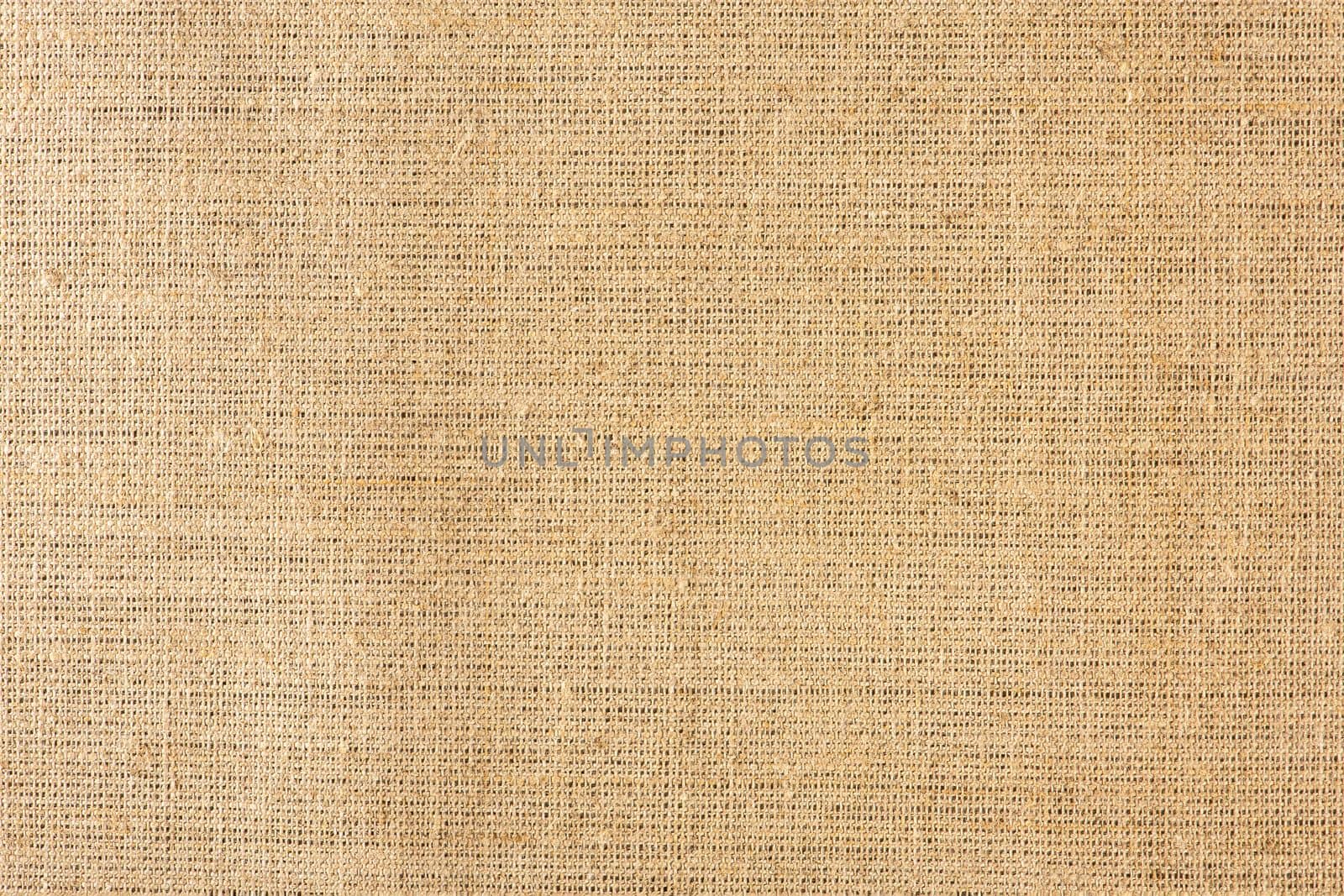 Texture of linen fabric in natural yellow color. The surface of the linen fabric as a background or banner, close-up