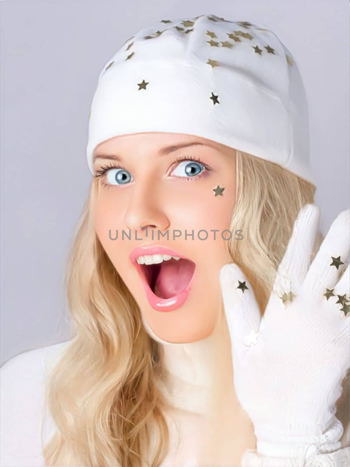 Merry Christmas, good holidays and woman dressed in white hat and gloves. On studio background, beauty and fashion female model. Surprised humorous blonde girl smiles and enjoys the Christmas, New Year, and winter holiday lifestyle by Anneleven