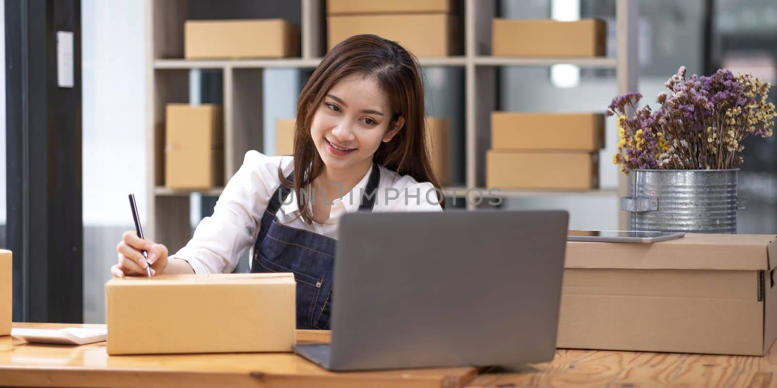 Successful entrepreneur business woman with online sales and Parcel shipping in her home office, prepare parcel box of product for deliver to customer...