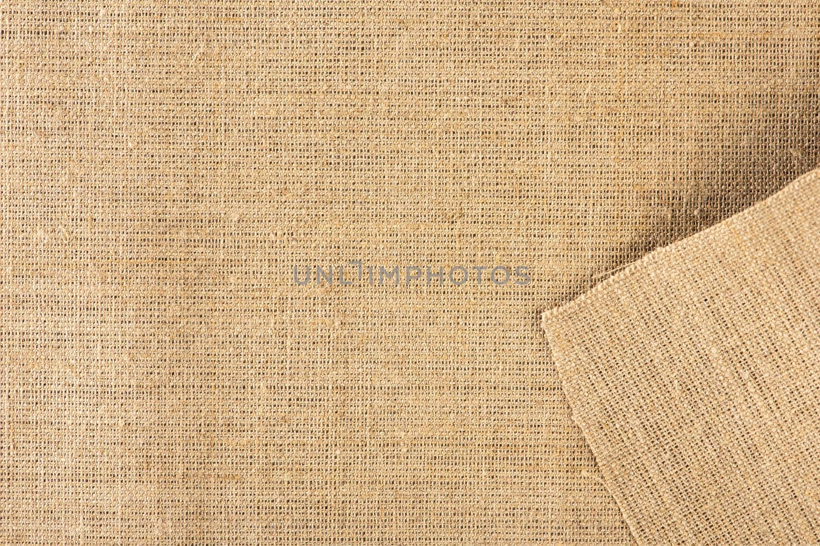 Texture of linen fabric in natural yellow color. The surface of the linen fabric as a background or banner, close-up. by SERSOL