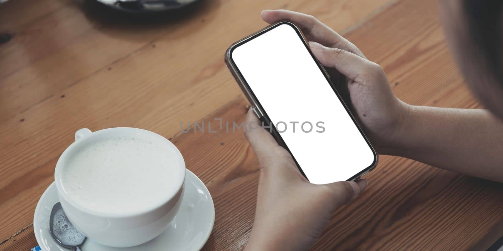 Close up of woman using cell phone,sending massages on the coffee shop.having sunbath.Phone with black screen,texting,video calls,..