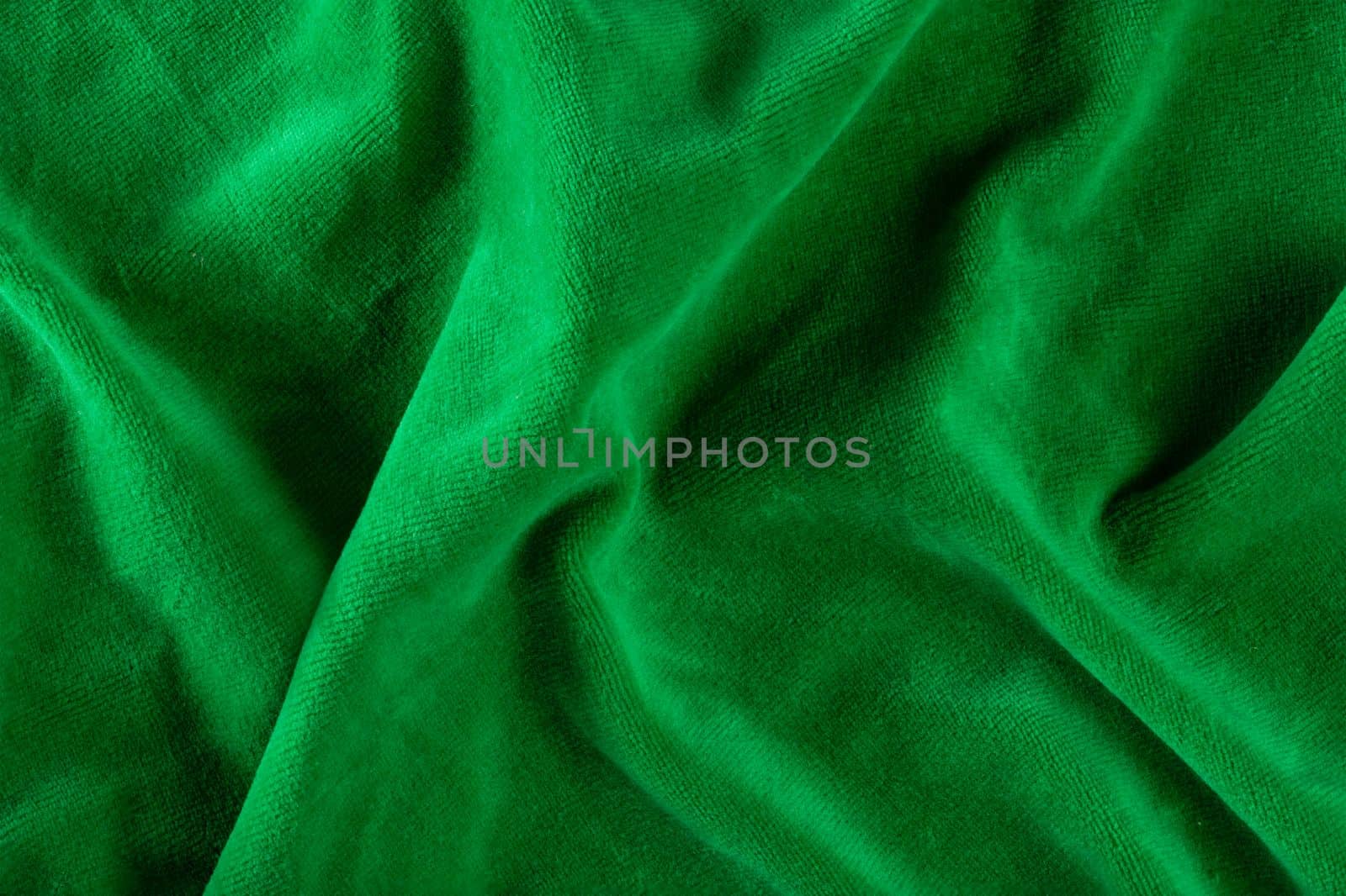 The texture of a microfiber cloth close-up. Napkins for cleaning and cleaning green surfaces. Washable