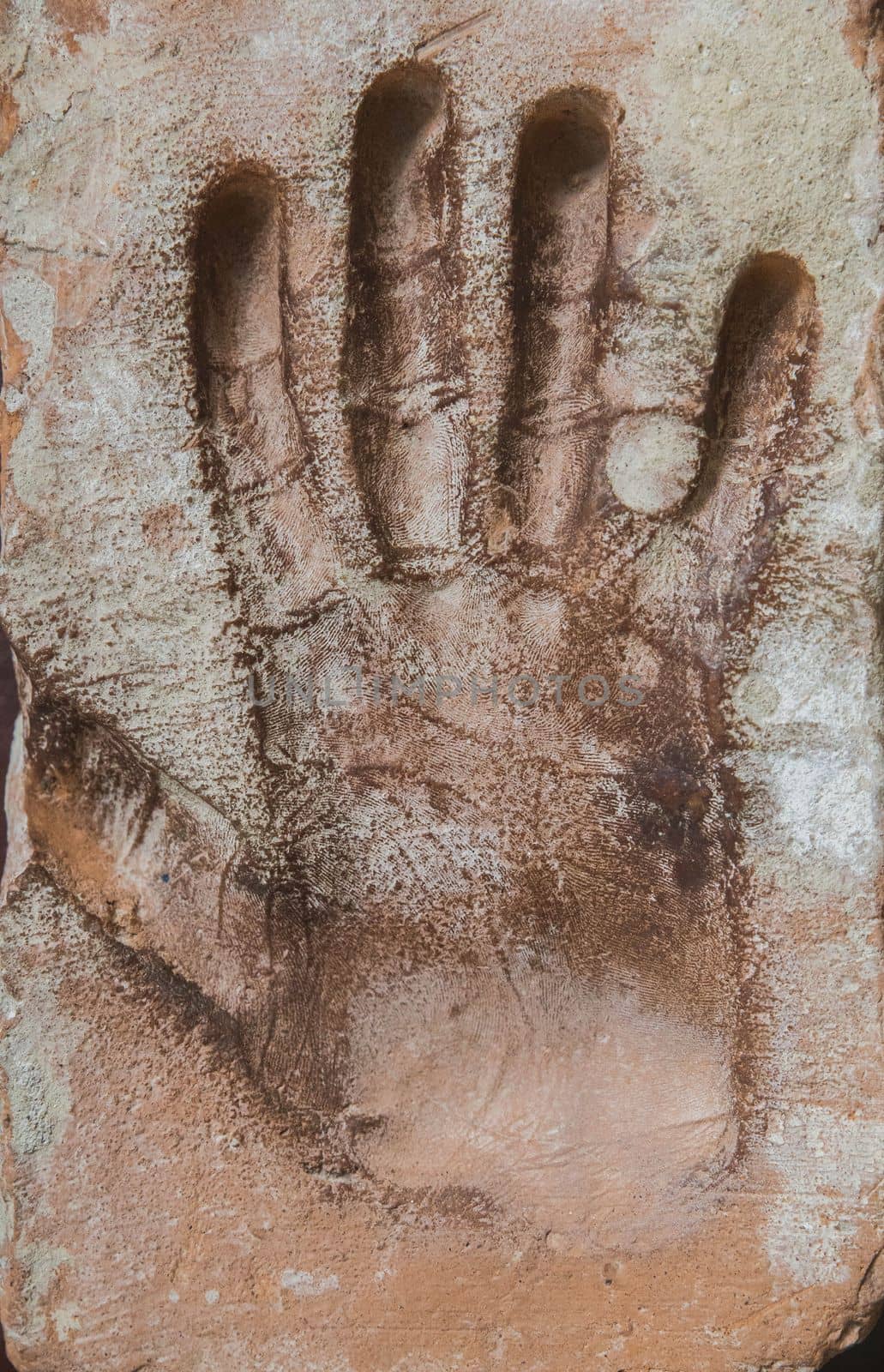 Old dirty concrete background with male handprint.
