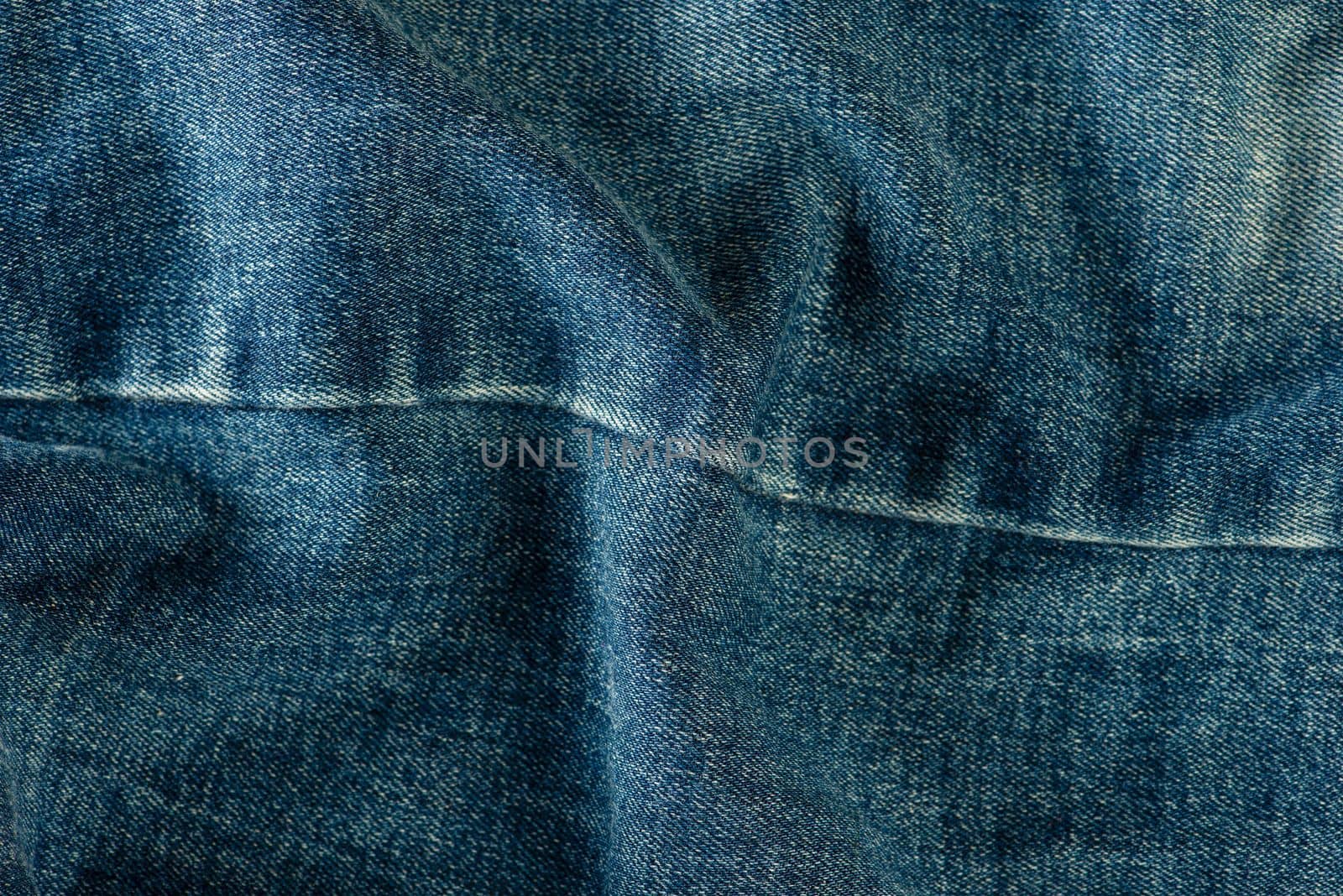 Texture of denim close-up. Jeans seam with place for text.