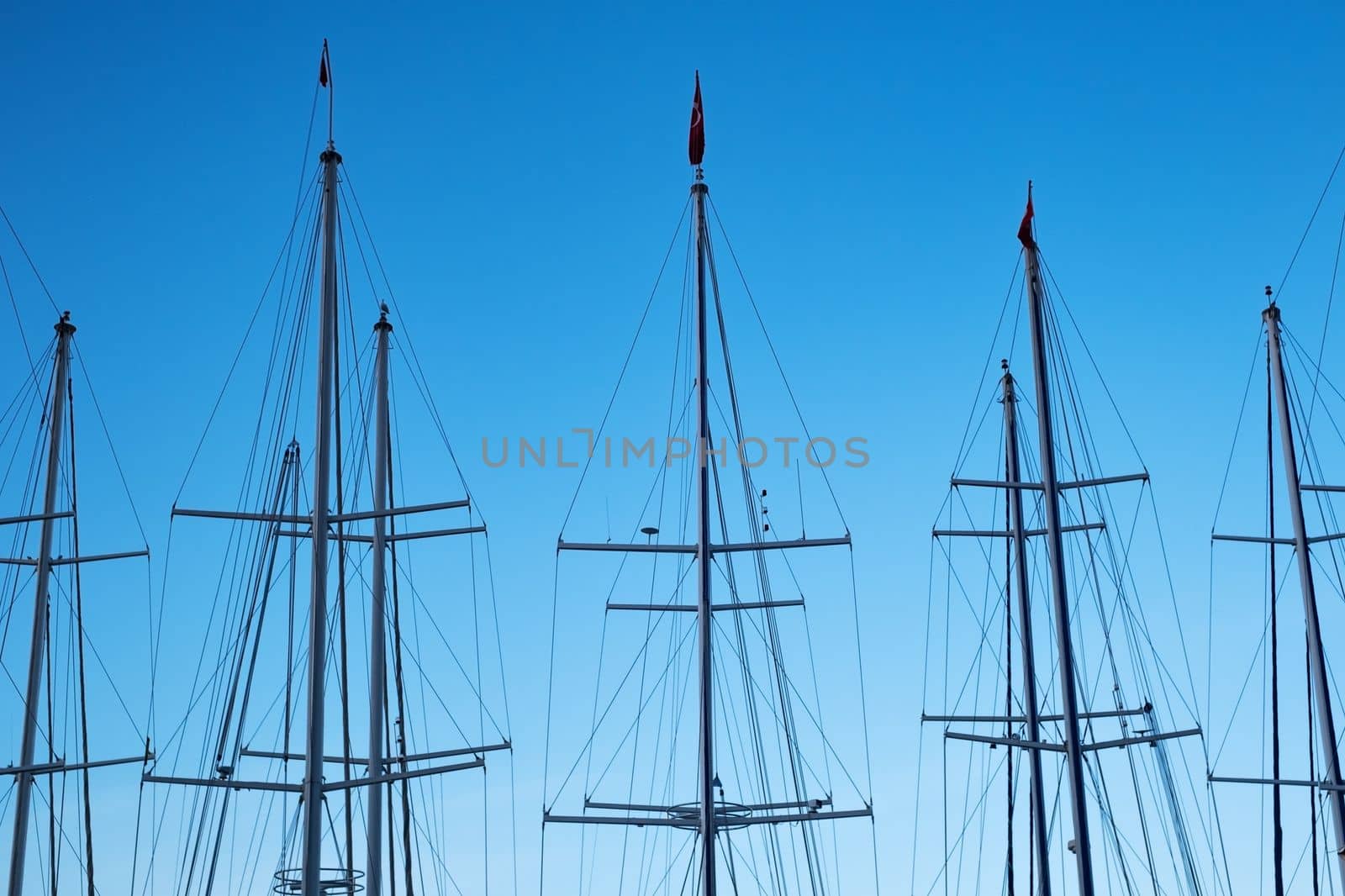 Close-up of yacht masts against the sunset sky. Marine theme. High quality photo