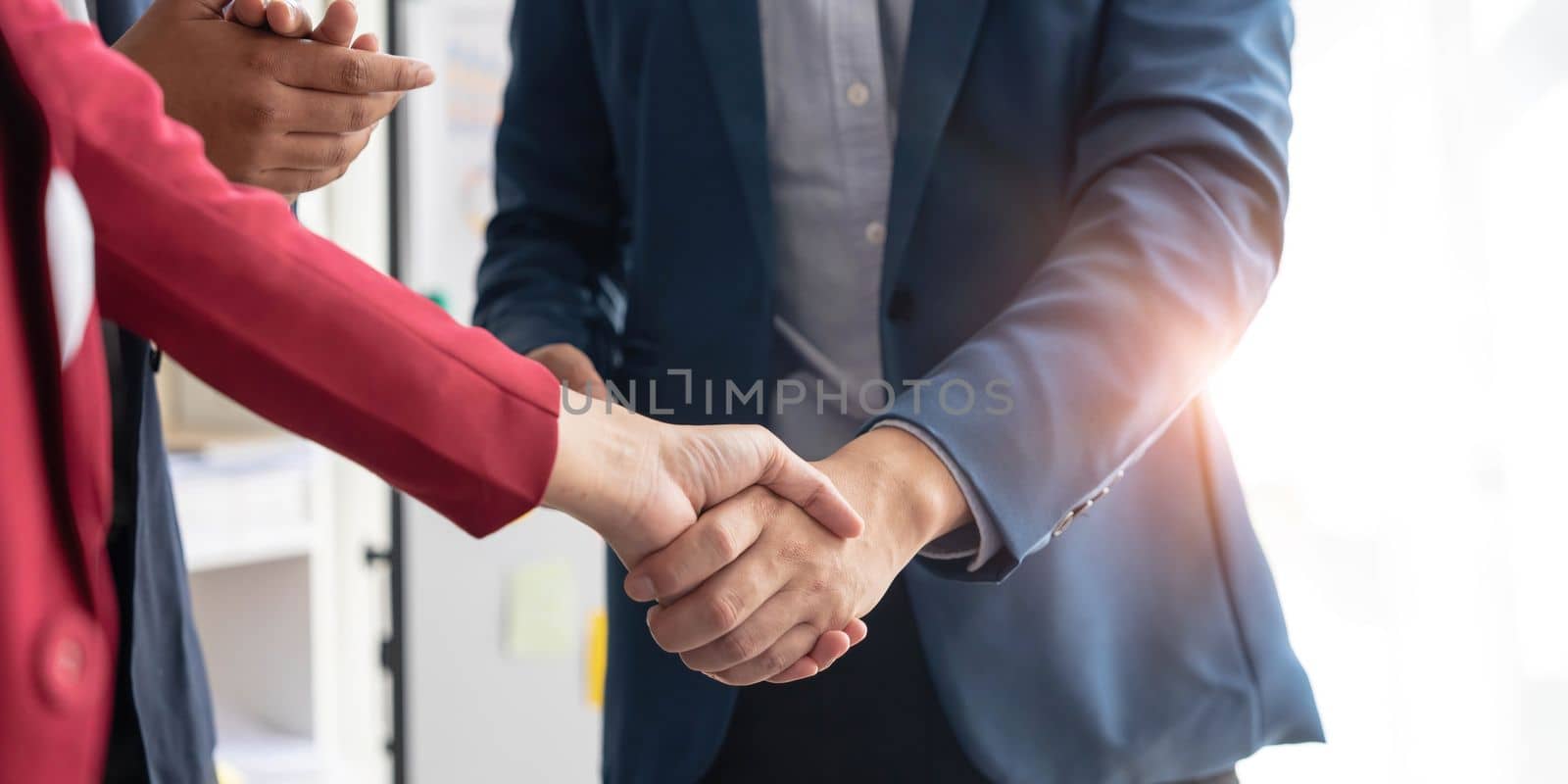 Business handshake for teamwork of business merger and acquisition,successful negotiate,hand shake,two businessman shake hand with partner to celebration partnership and business deal concept...